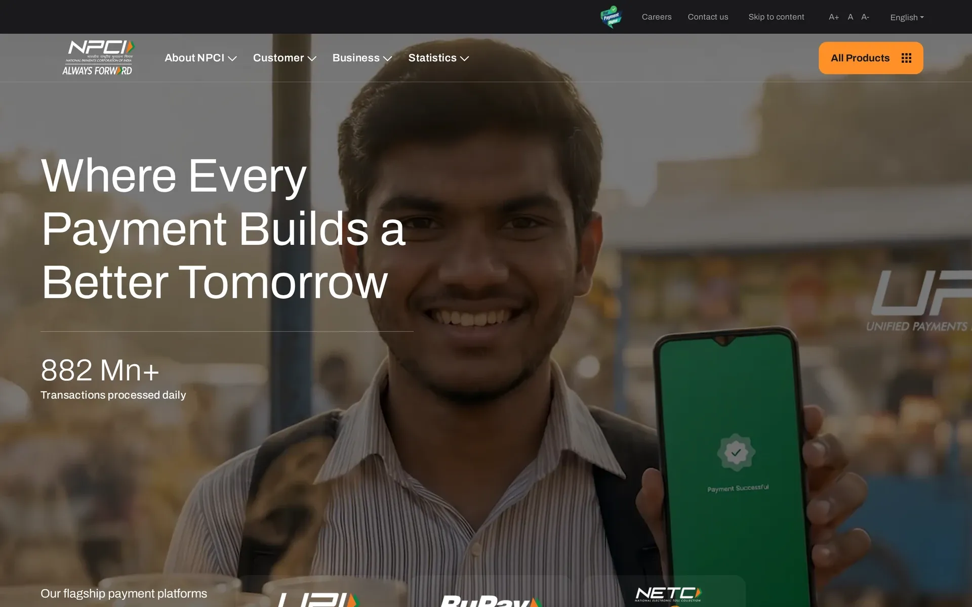 UPI on NPCI's homepage: man holding a phone showing “Payment Successful” beside “Where Every Payment Builds a Better…